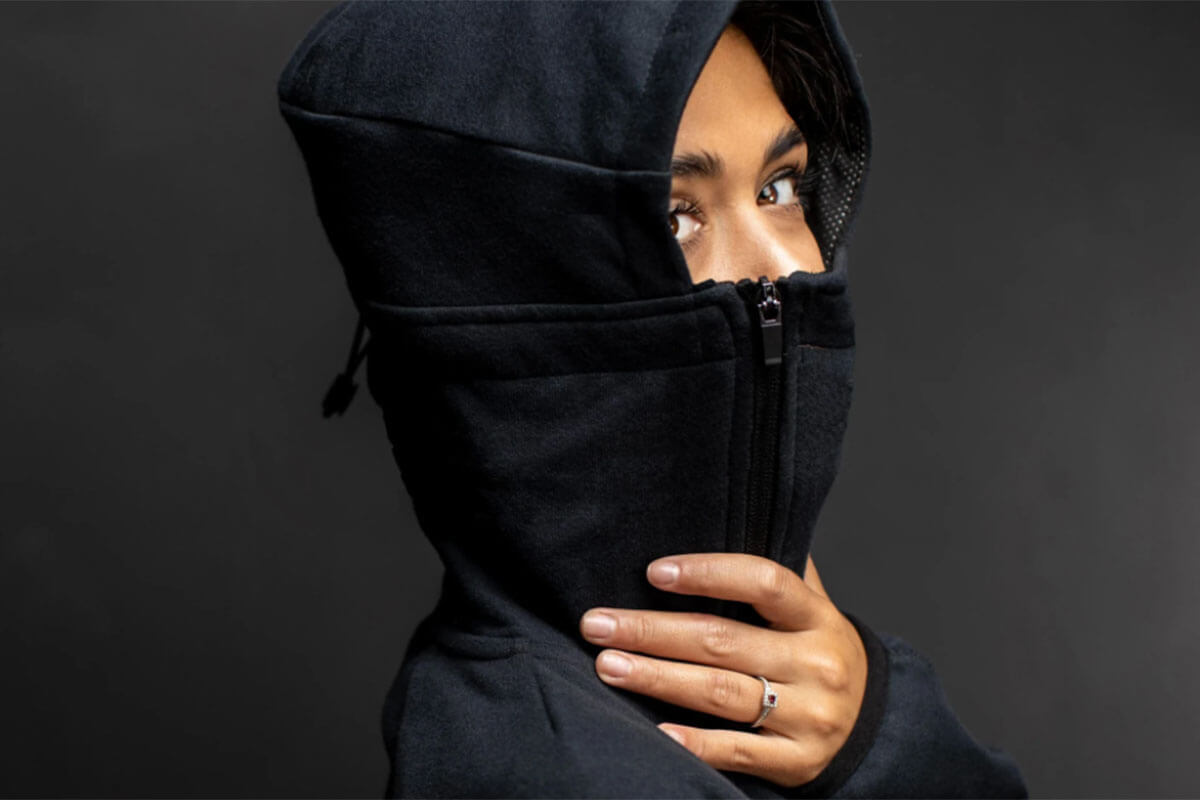 Toast Fashion Trend Forecasts for 2021 include the Bio Hoodie from G95, and this shows a hood with the  built-in mask zipped up over the girl's nose.