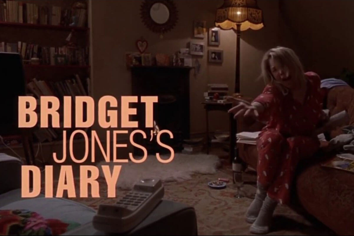 An upset Bridget Jones sitting on the couch in pajamas, one of Toast's curated must-watch TV & movie classics