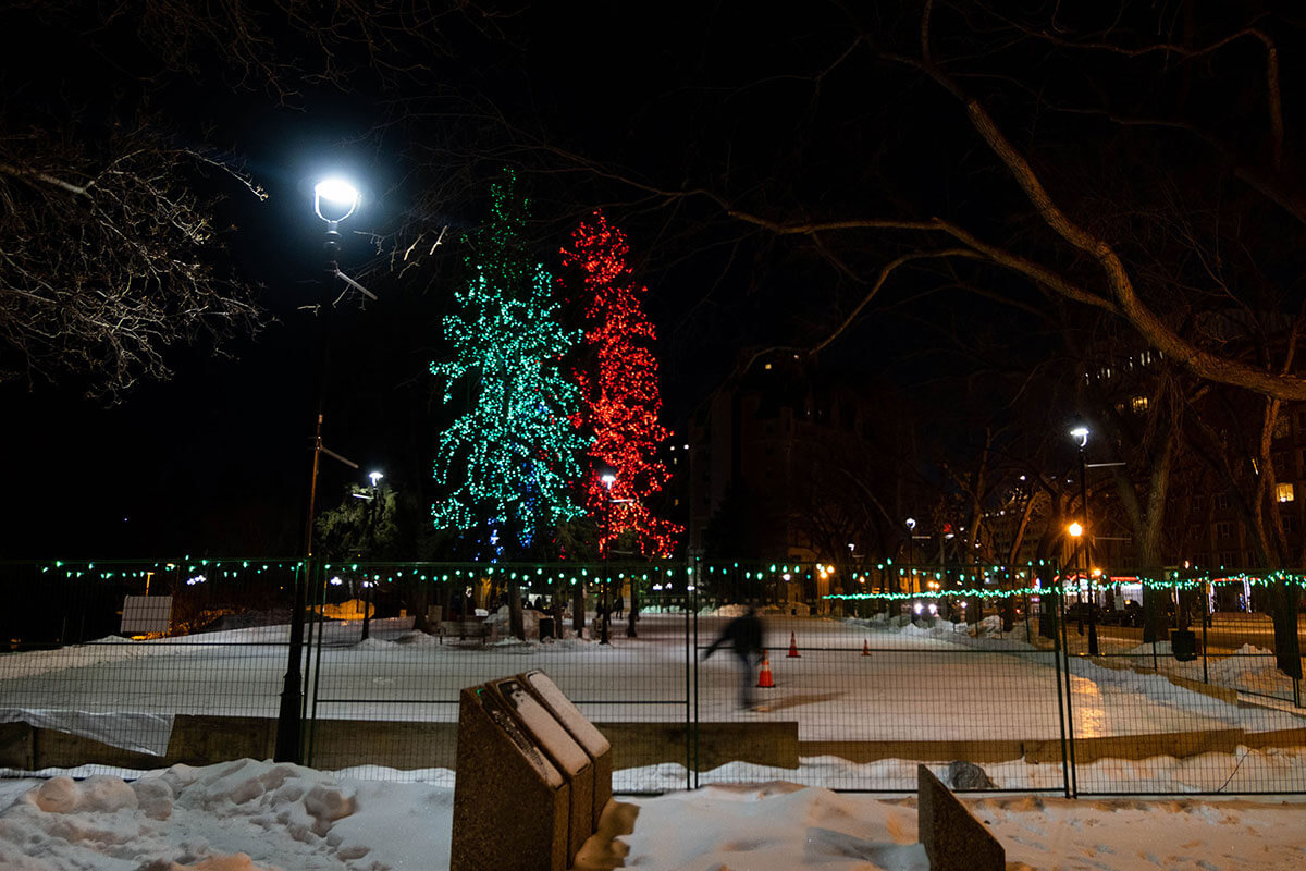 The Meewasin Skating Rink lit up with colourful lights at night, part of the Saskatoon January City Guide