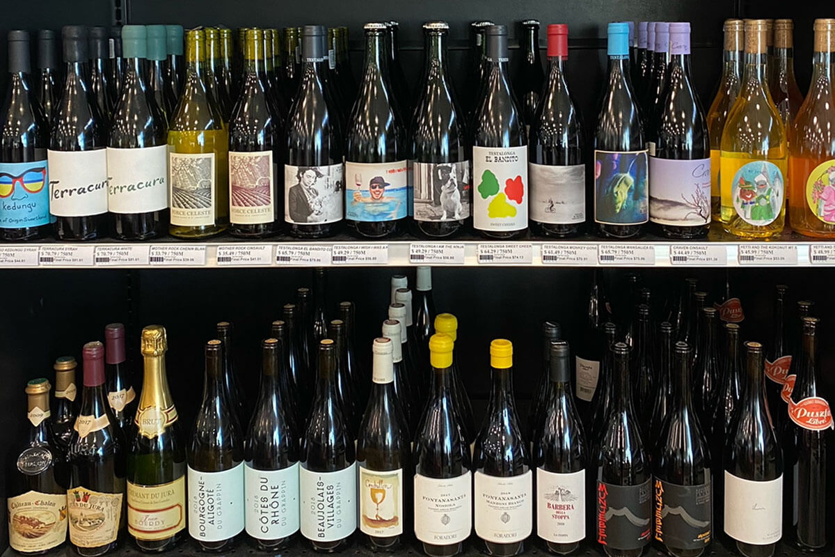 Two stocked shelves of sustainably-farmed natural wines at Metro Liquor Stores