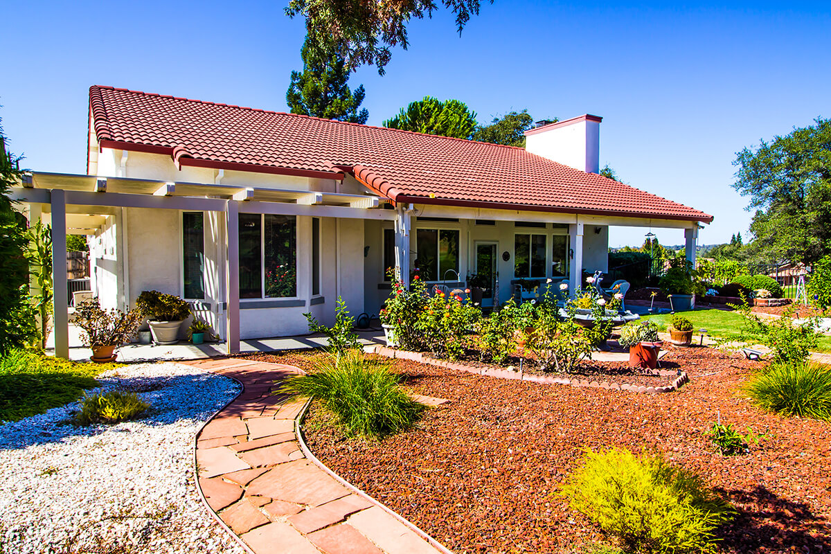 A xeriscaped yard with limited turf grass lawn.