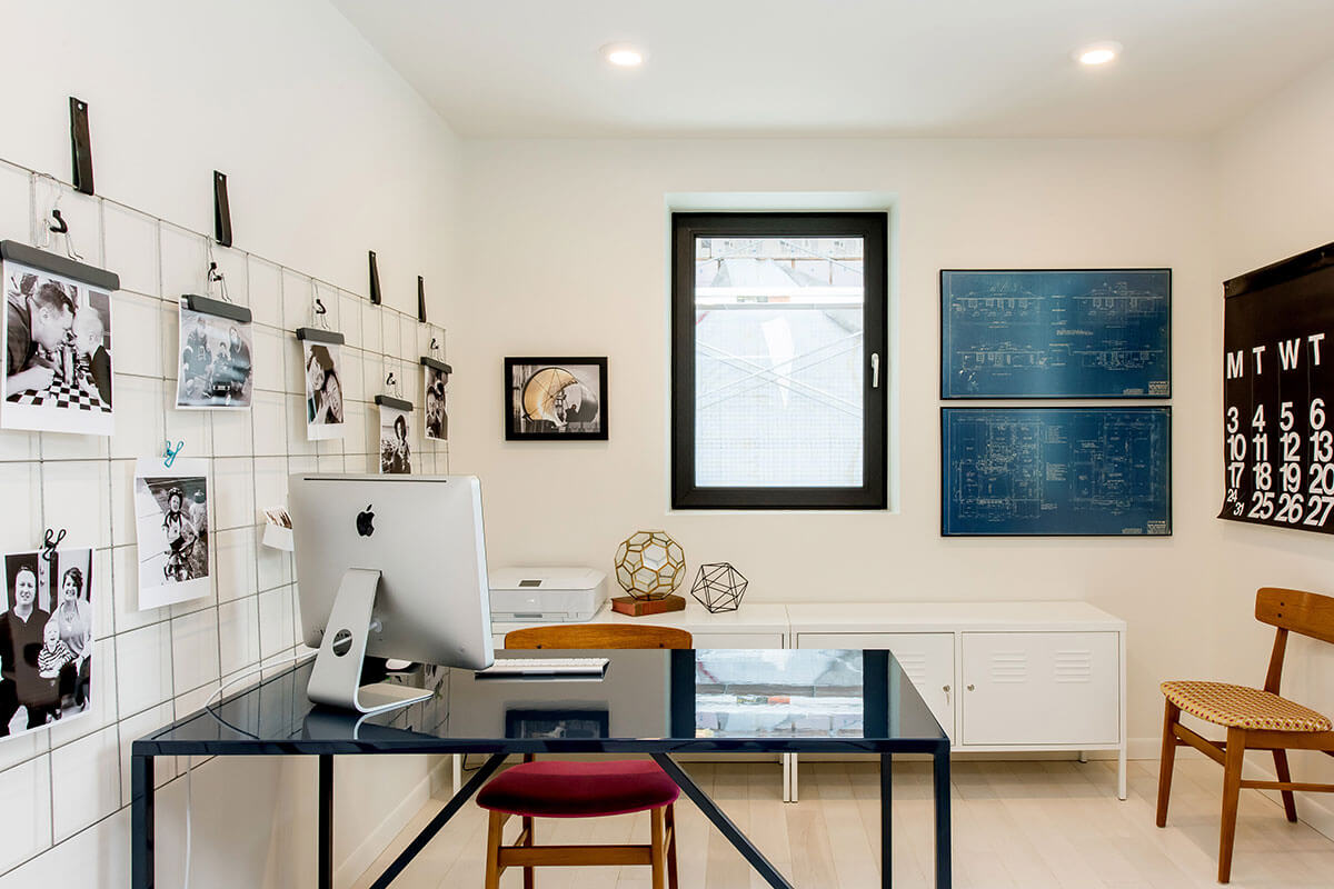 Home office with black table, accessories and white walls, part of 2021 home renovation trends