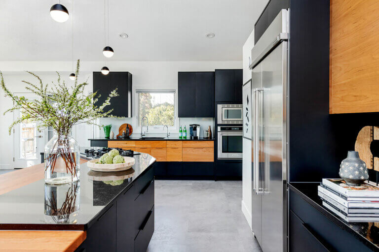 black, brown & stainless steel kitchen with grey flooring