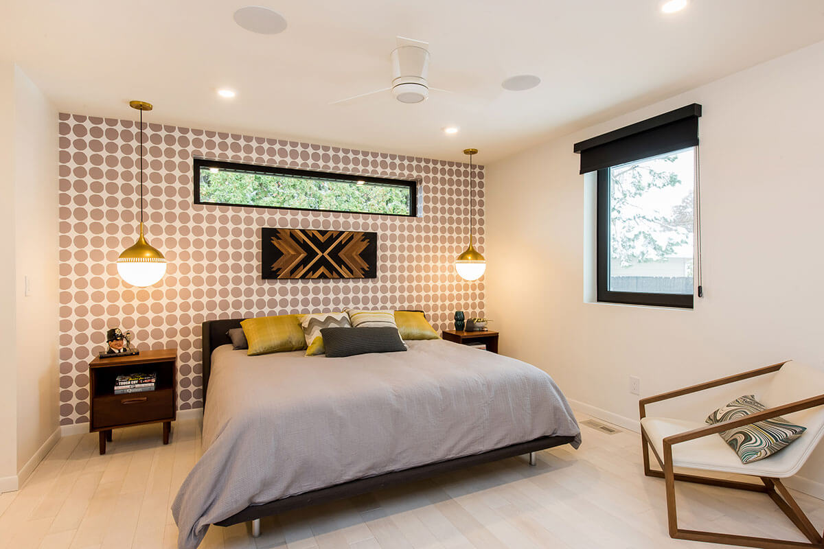 A bedroom with a feature wall of gold & white wallpaper, one of our 2021 home renovation trends