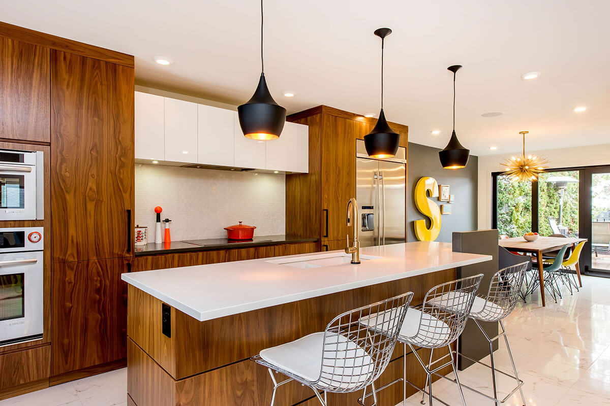 A kitchen with bronze-brown cupboards, white countertop and white floors, part of the 2021 home renovation trends