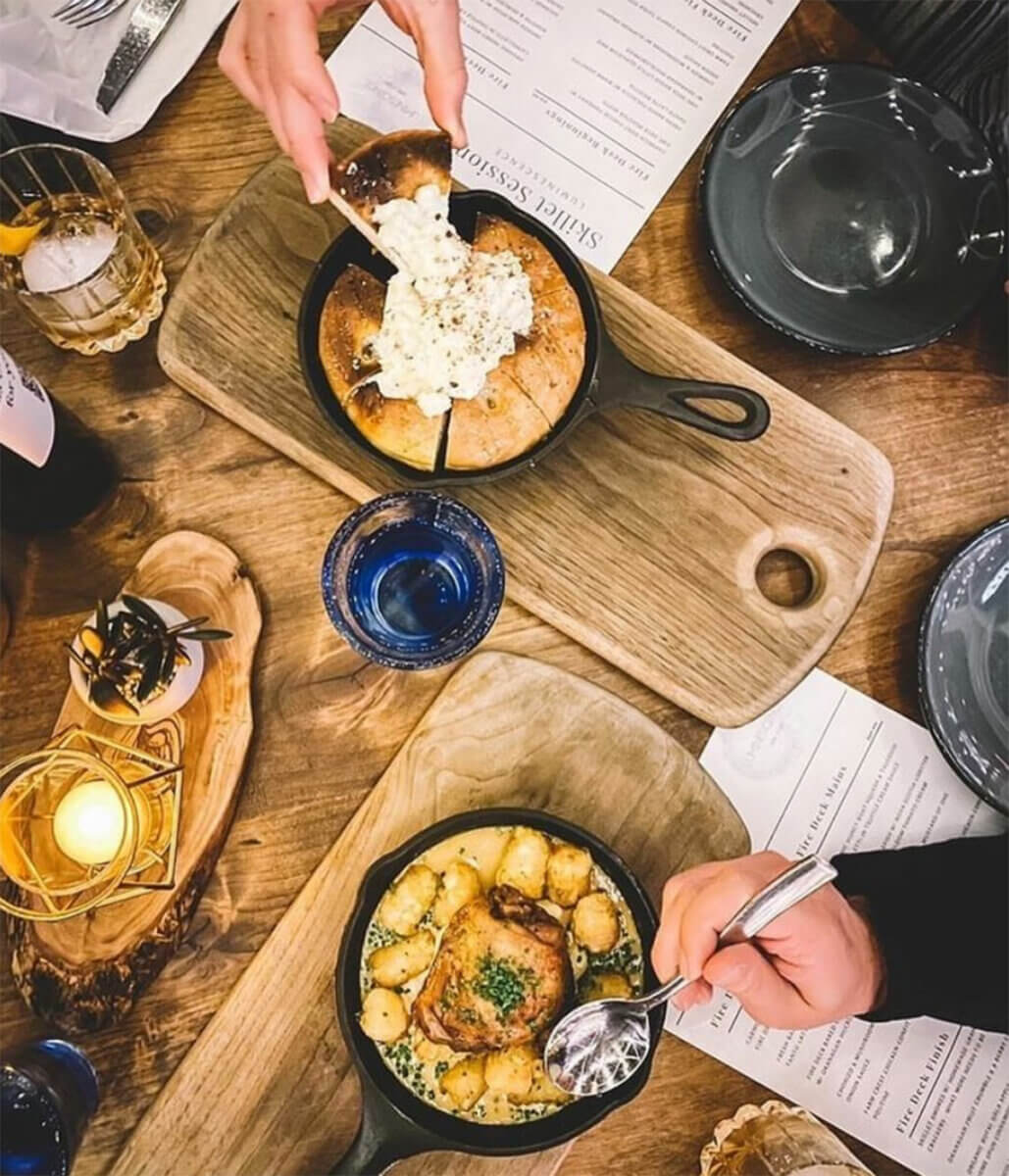 a variety of appetizers on boards at Oak + Cru, an example of recommended food & wine in Kelowna, BC