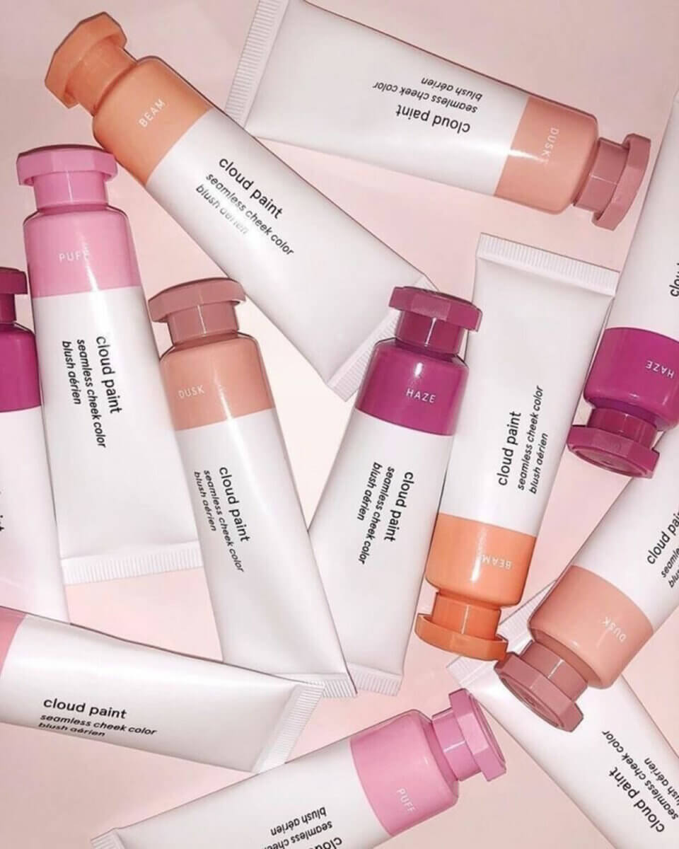Tubes of pink, beige and peach Glossier's Cloud Paint, some of Holly Decker's favourite hydrating skin products