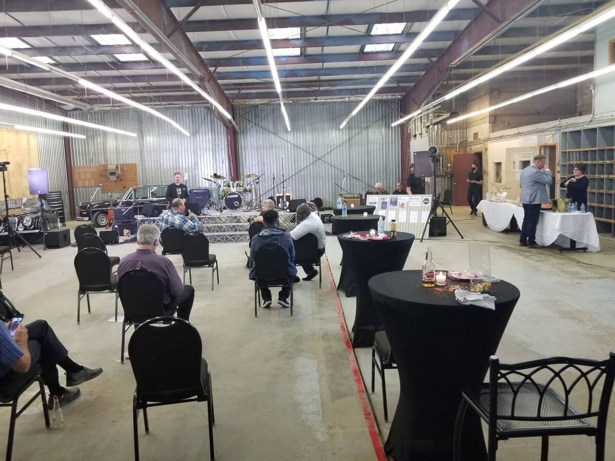 The Garage Band and about 20 spectators in a converted bay next to  The Caring Place, taking a break at the "point of contact" fundraiser