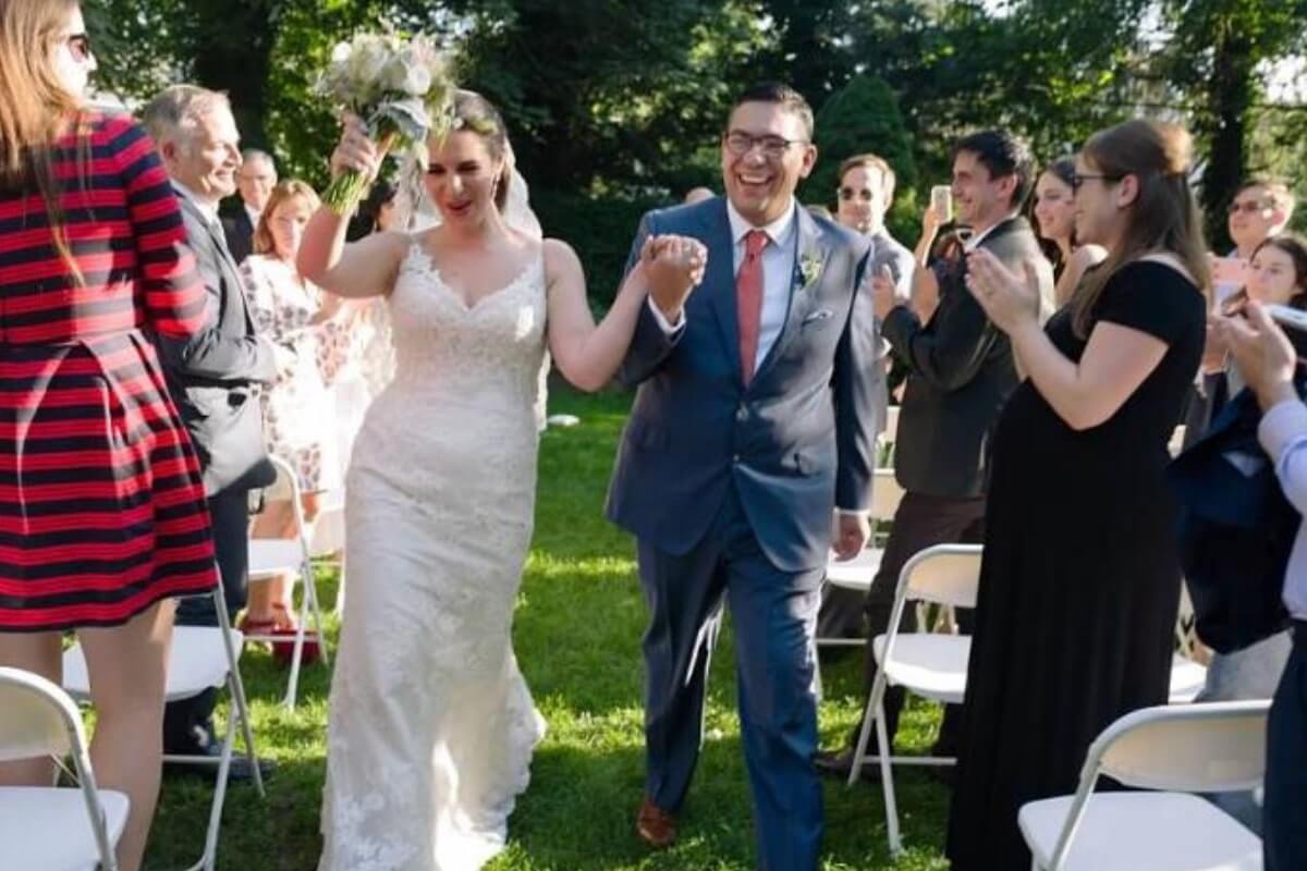 wedding couple walking past guests, as part of a sustainable covid wedding