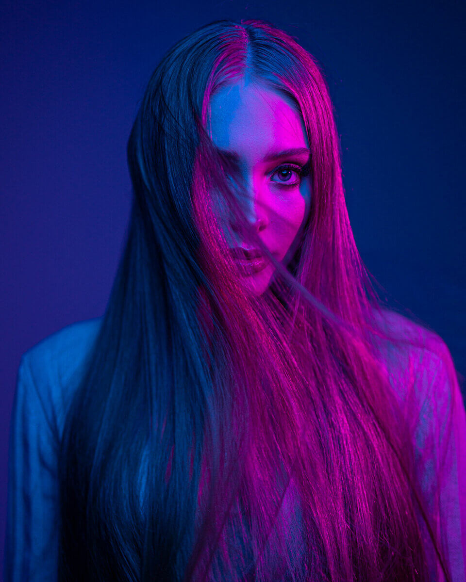 Coloured light mixing portraits of a long-haired model started with magenta and blue