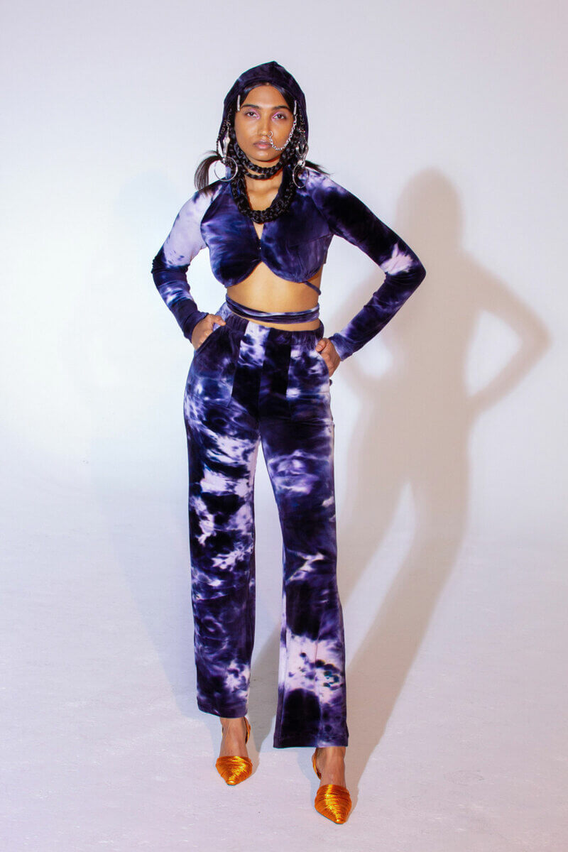 Model wearing revealing 2 piece blue, purple and white tie-died long sleeve top & pants with orange shoes, by Kim Shui RTW fall 2021 fashion collections