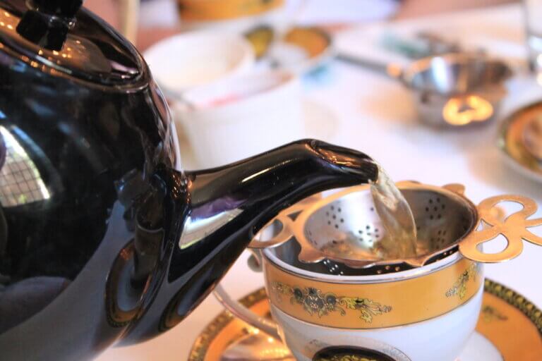 tea being poured into a cup in high tea restaurants in Toronto