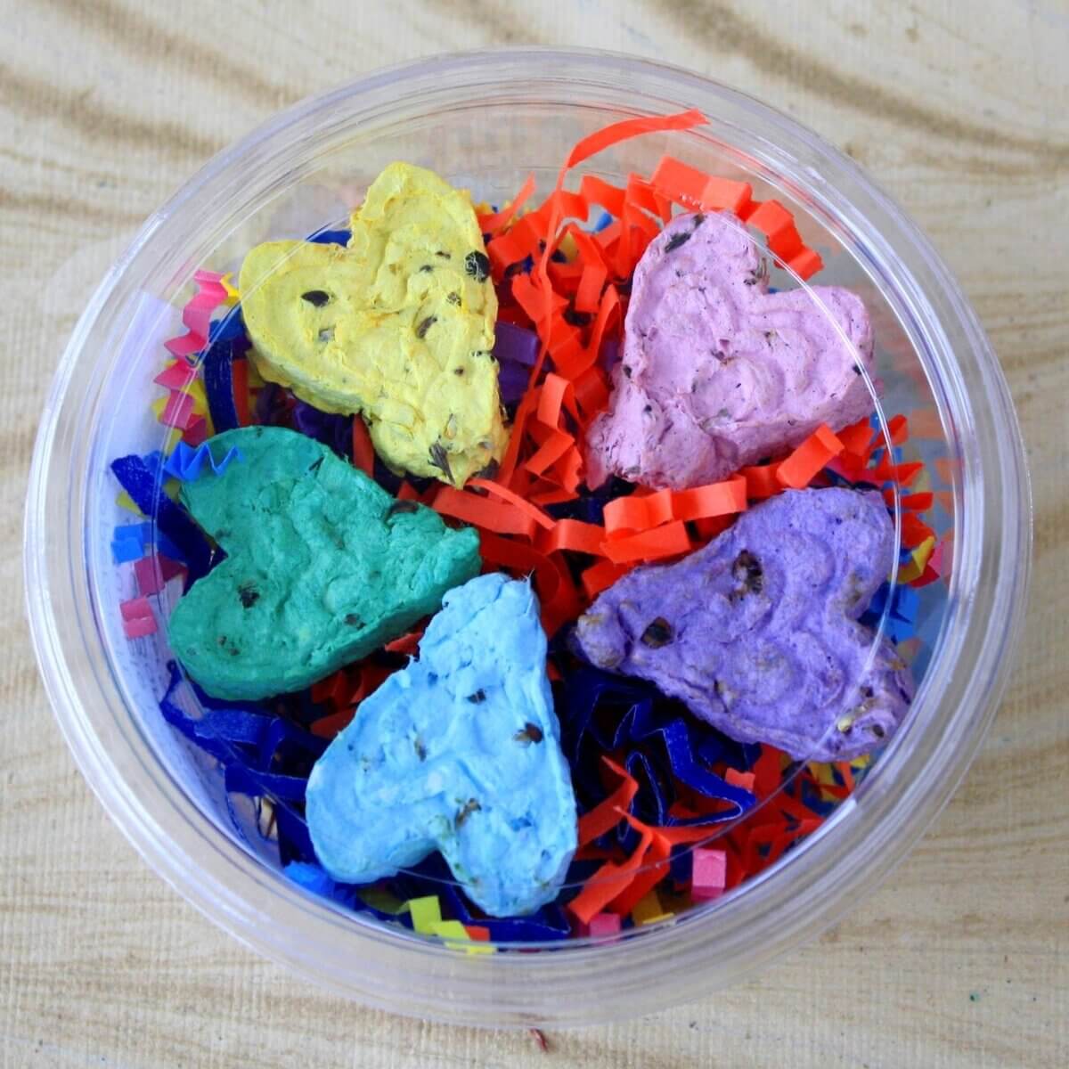 A multi-coloured bowl of seed bombs for planting wildflowers