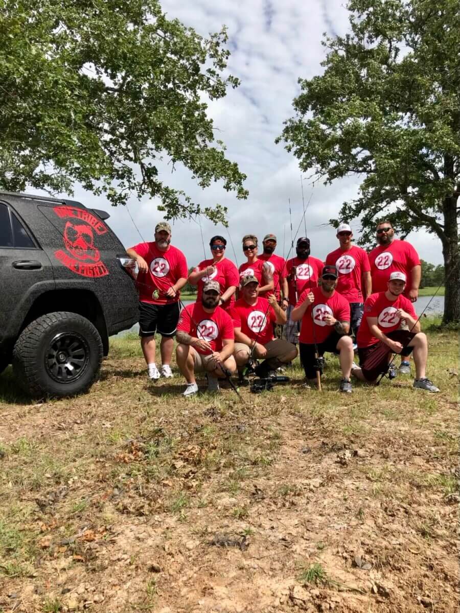 a group of participants in red team t-shirts ready to fish in the 22Kill Forge program