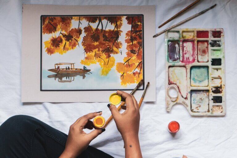 an artist painting a picture of yellow and orange flowers, Canadian art institutions