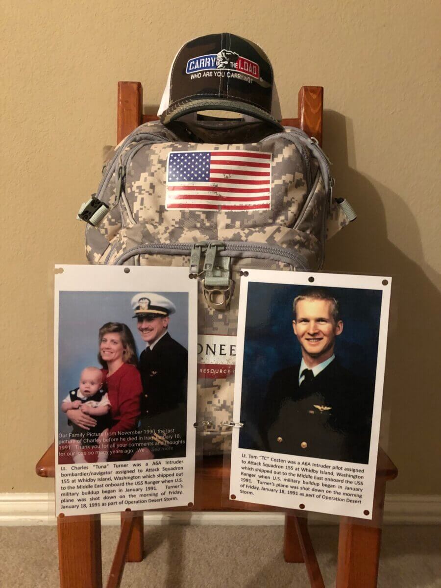 a memorial display of photos and a pack for a US fallen officer at a carry the load event in dallas