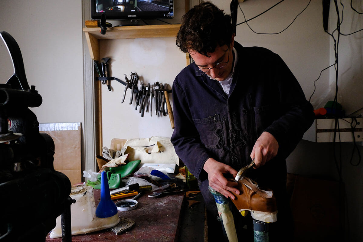Shoemaker Adam Finn building custom made shoes