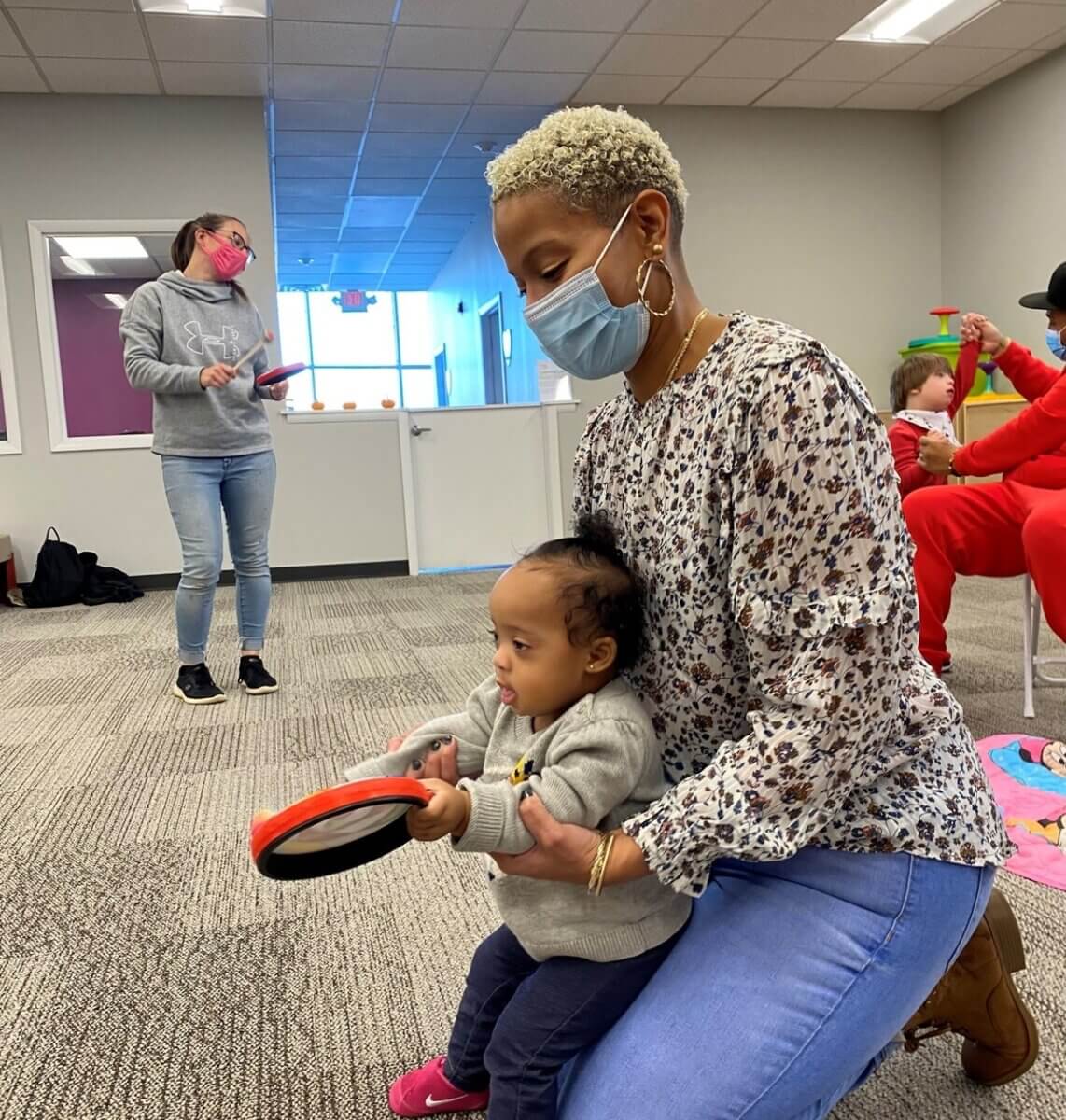 motter and daughter playing with toys at feelings rock that helps kids