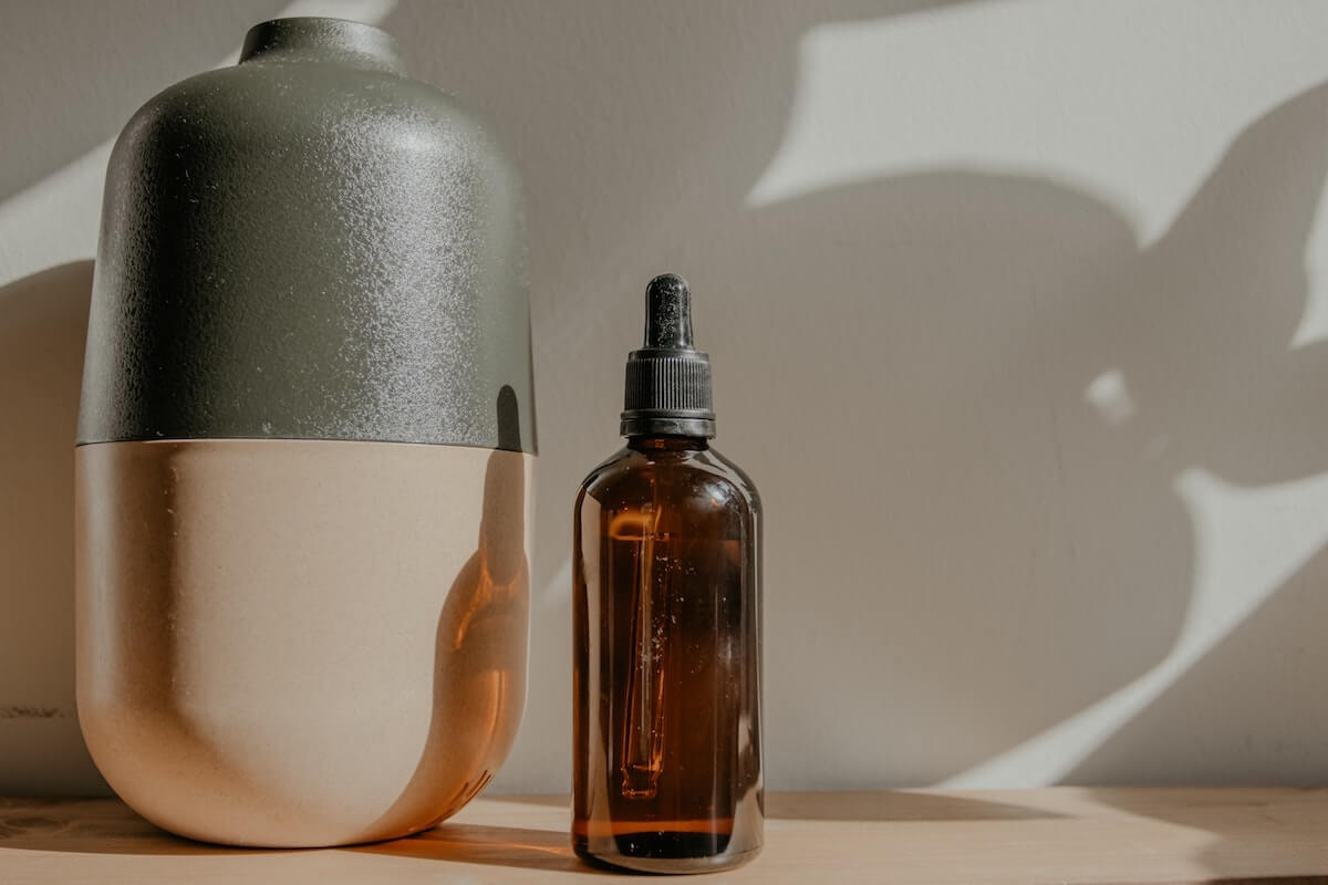 diffuser beside a bottle of essential oll to help keep fresh air in a small space