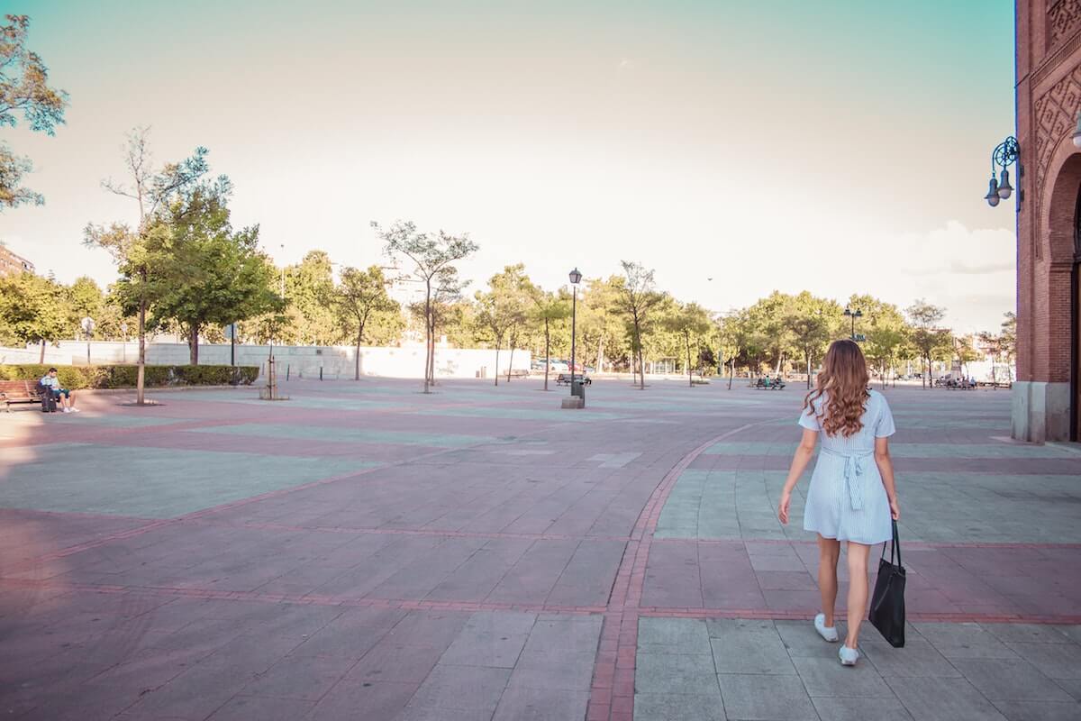 woman on a hot girl walk in summer in an urban setting