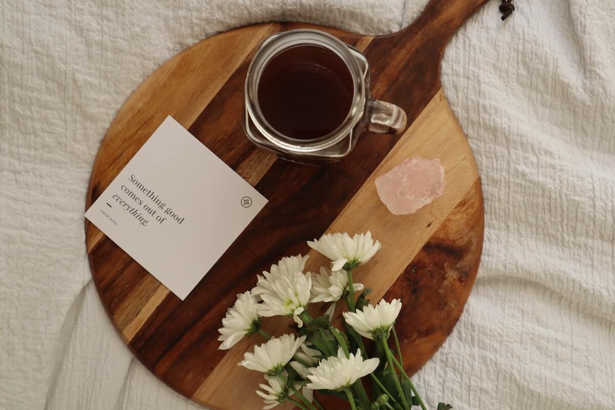 an affirmation, flowers and salt on a wooden board, one of 4 simple ways to get a better sleep