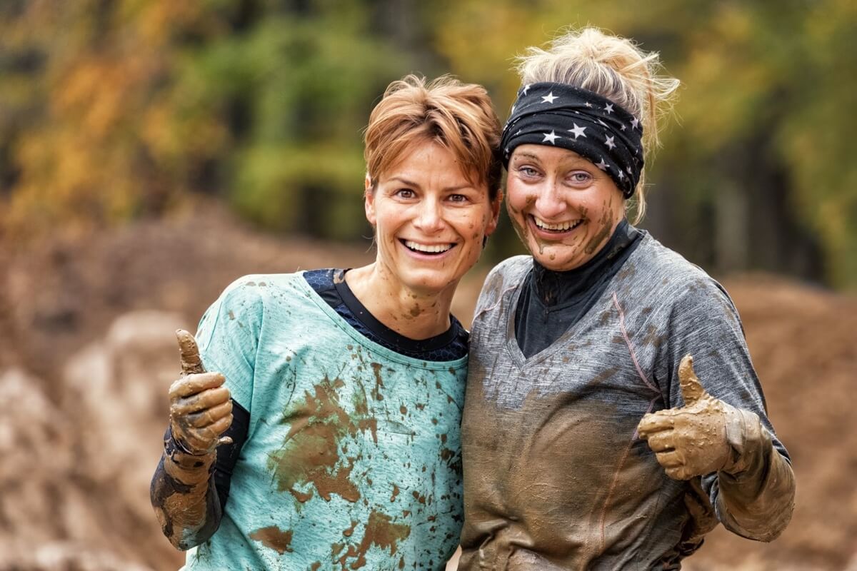 two women after a mud run, muddy milar family adventure