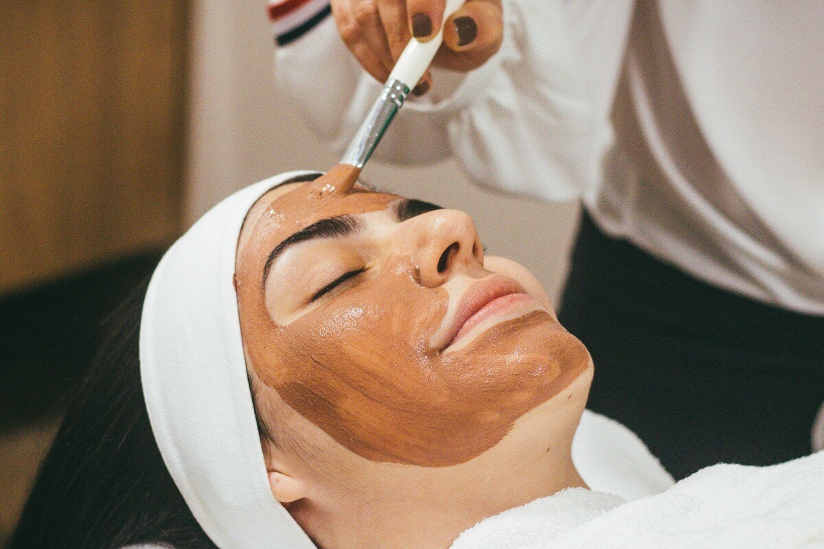 woman getting a facial, a pre-wedding beauty & wellness routine