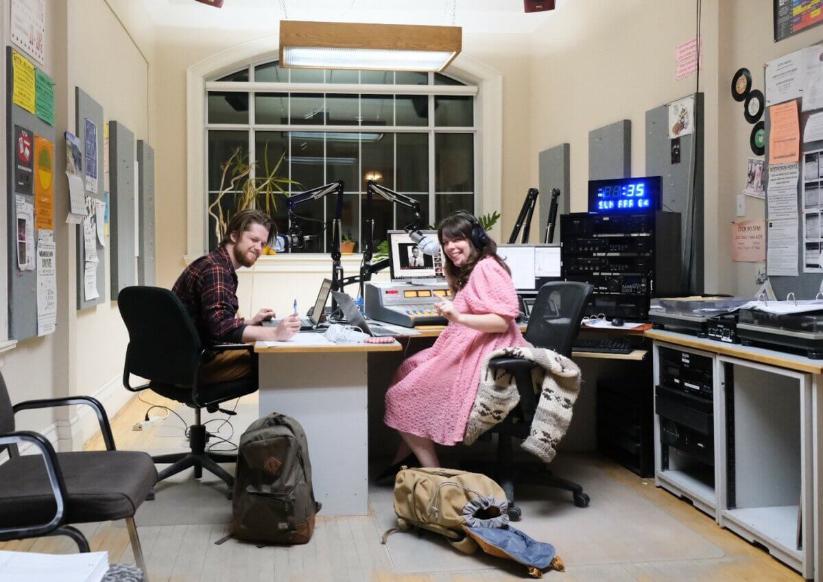 Man and woman recording a show inside Saskatoon community radio station