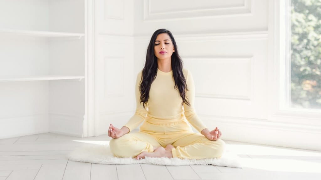 seated woman meditating, and spreading the mindful word