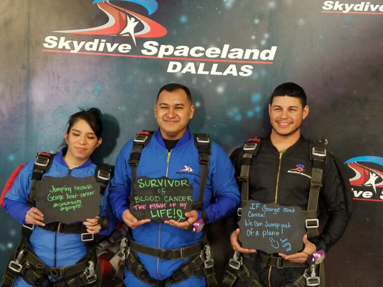 2 men and 1 woman skydiving at 2 miles for smiles