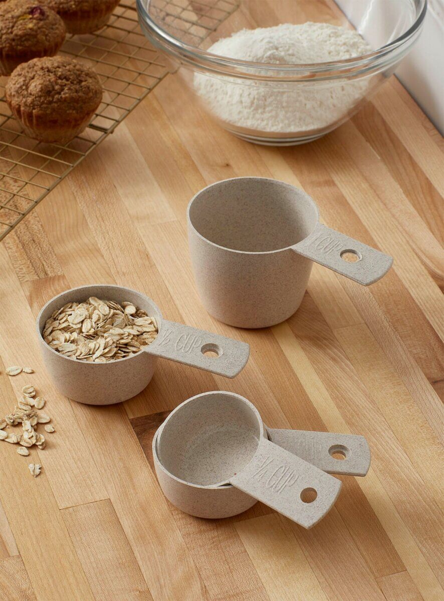 wheat husk measuring cups with bowl of flour and muffins