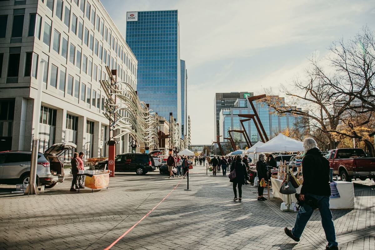 vendors and shoppers at a farmer's market, part of May activities in Regina