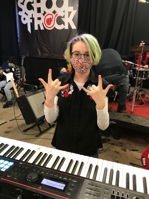 a music student rocking at a keyboard at Regina's School of Rock