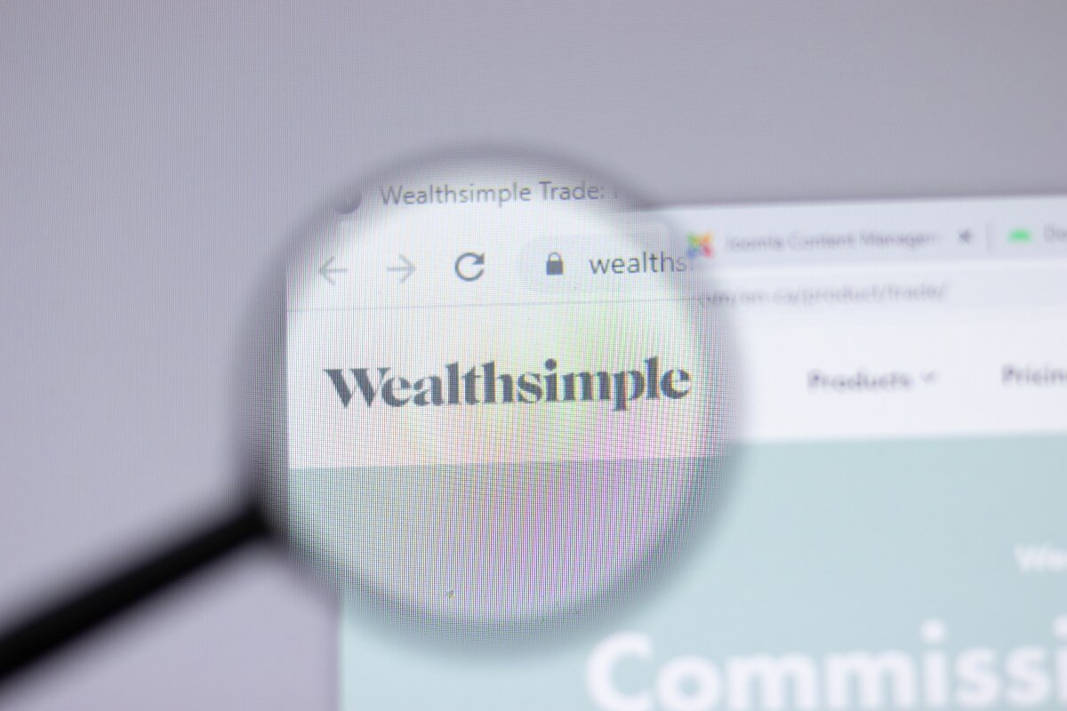 wealth simple investing app on a computer screen under a microscope