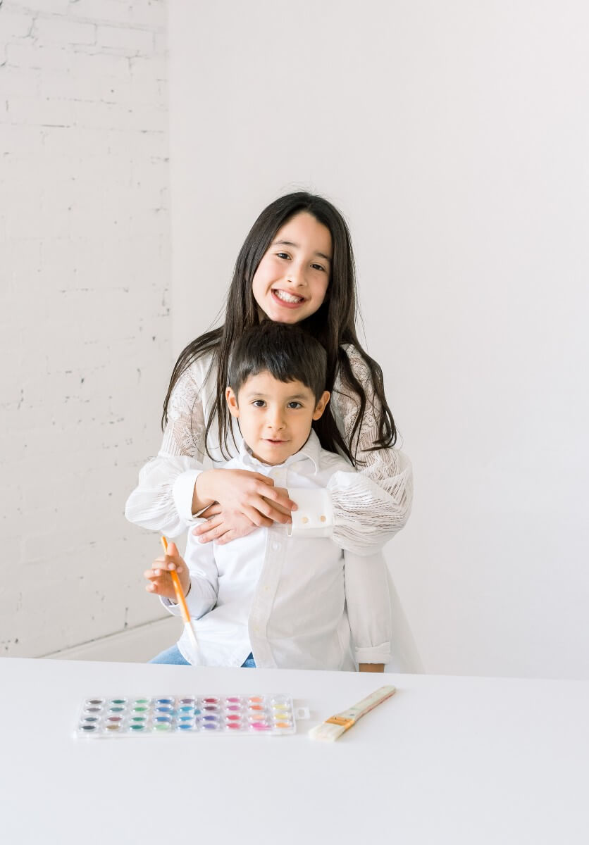 young boy and girl in white shirts, founders of shining brownies in dallas