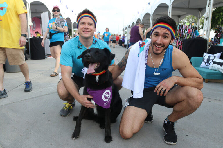 2 men runners with their black dog in strutt your mutt dallas