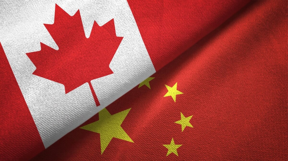 canadian & chinese flags draped together for chinese canadian leaders summit