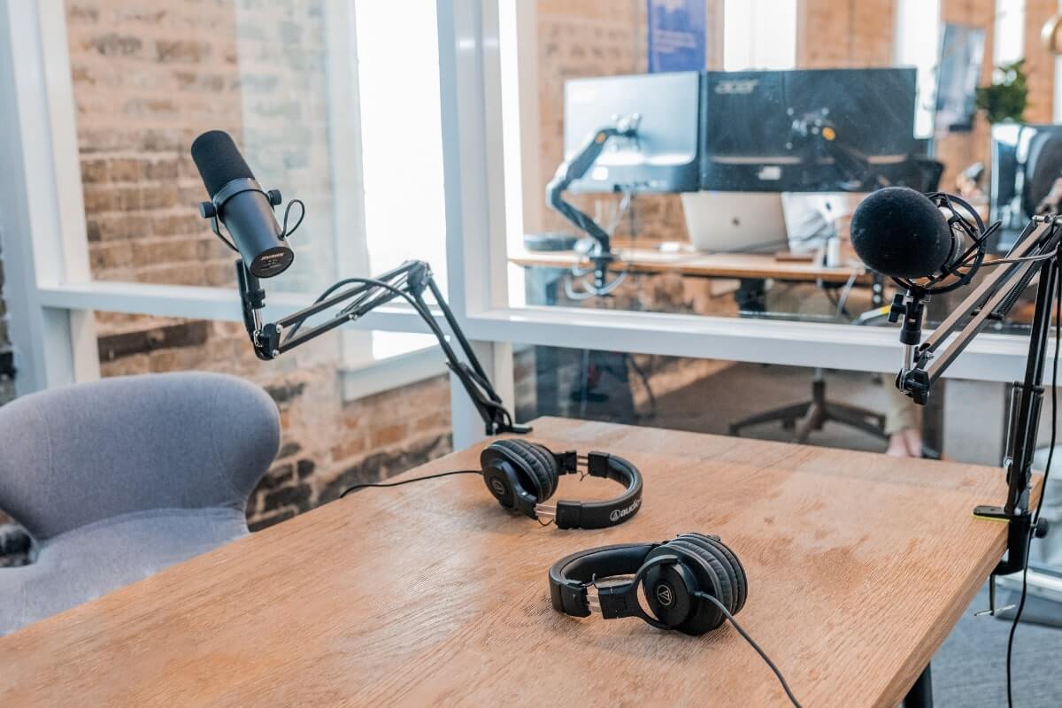 headphones, microphone and computers for Dear Media podcasting