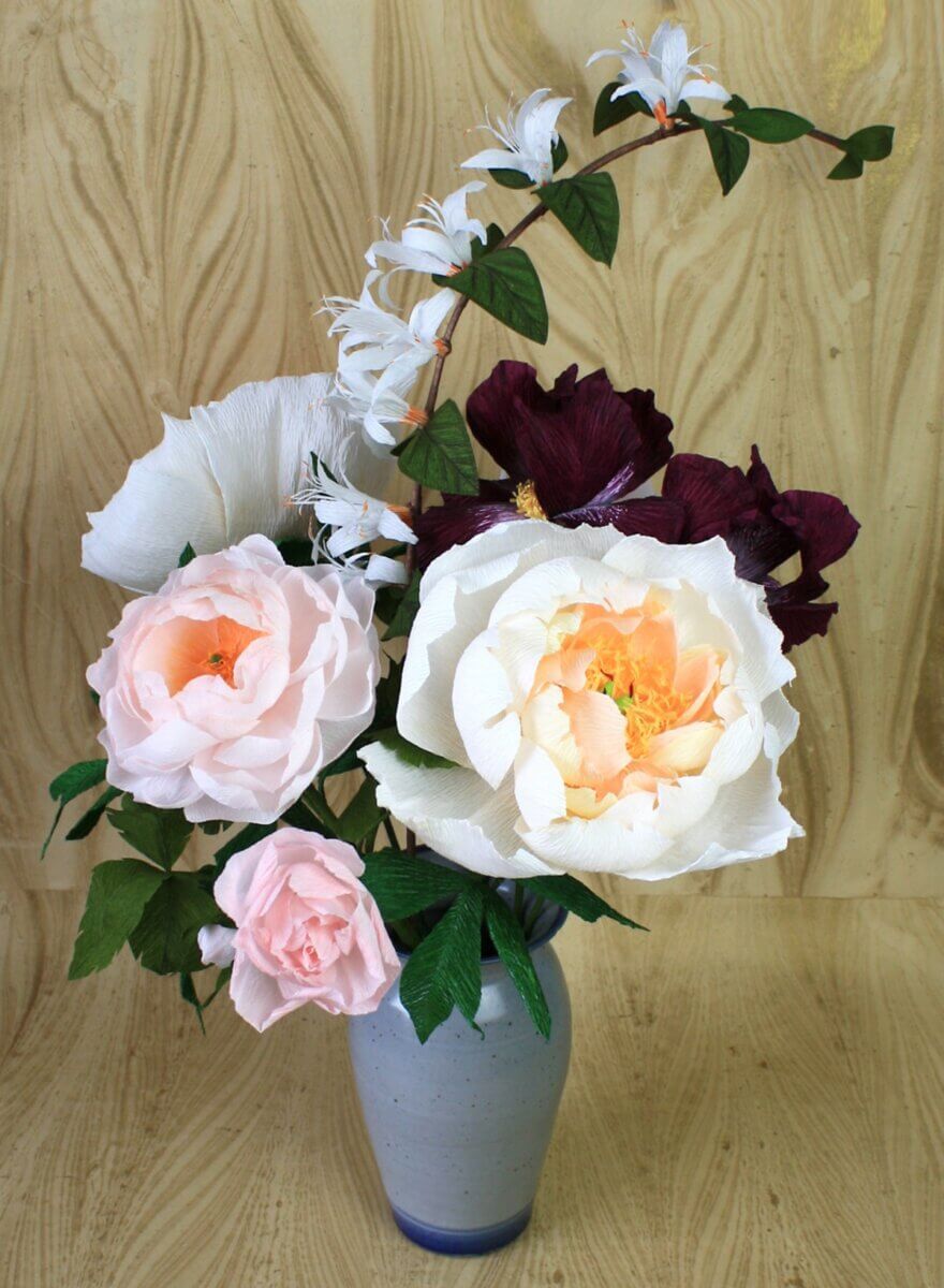 white, pink and burgundy flowers in a grey vase