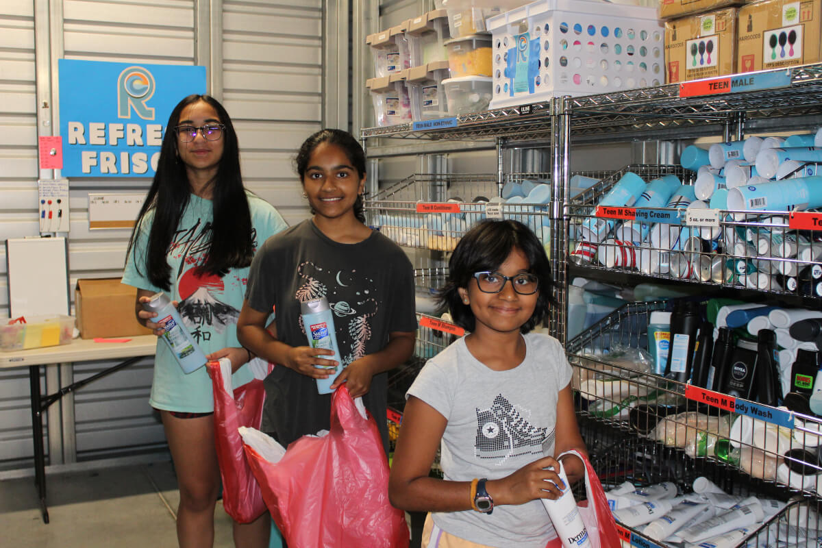 3 young girls benefiting from refresh frisco donates hygiene products