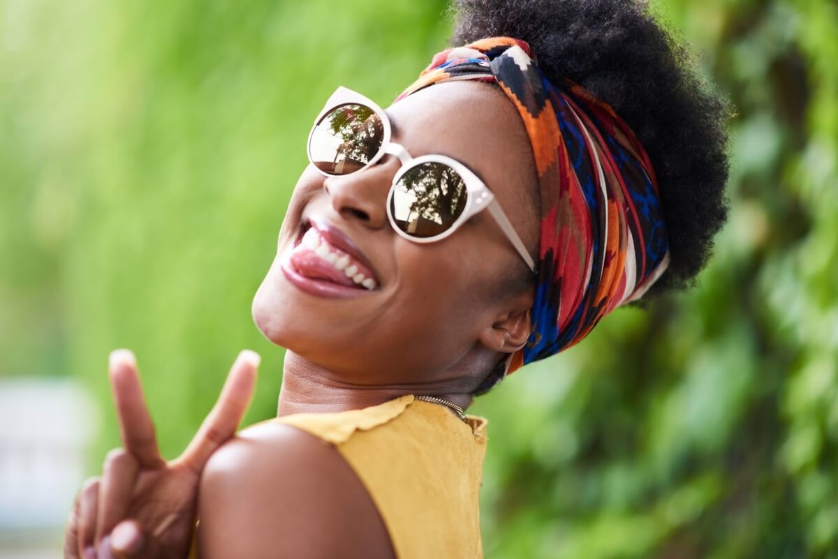 woman smiling and giving peace sign at escapes toronto carnival 2021