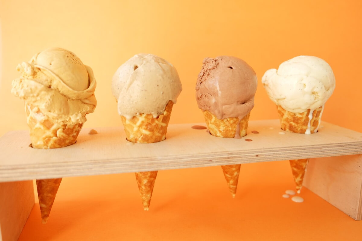 4 ice cream cones on an orange background