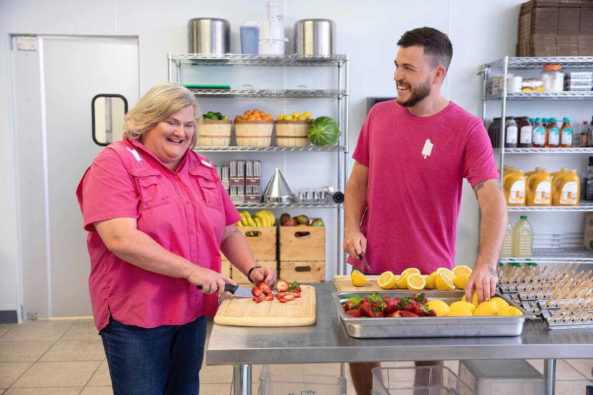 man and woman making ice pops with real fruit