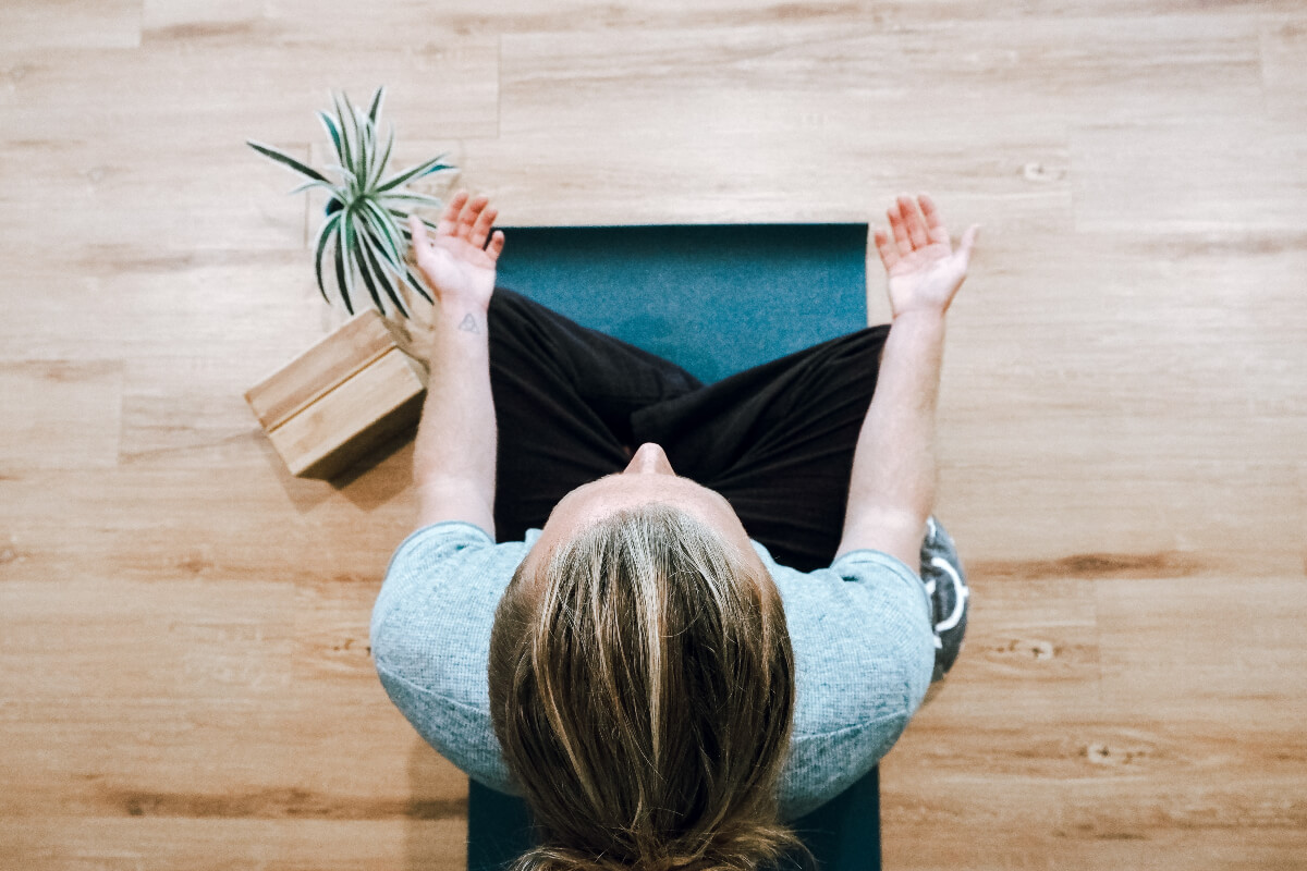 a woman meditating for mental wellness