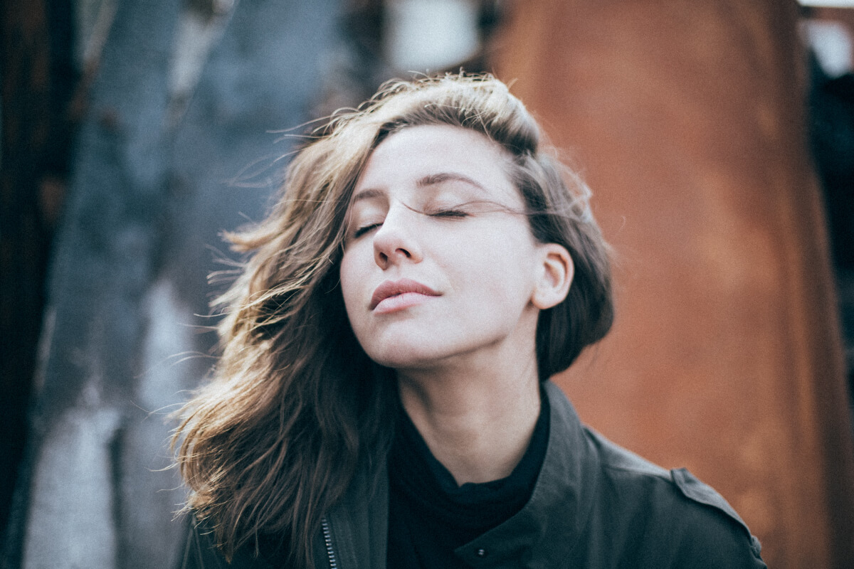 woman with eyes closed and looking calm and relaxed