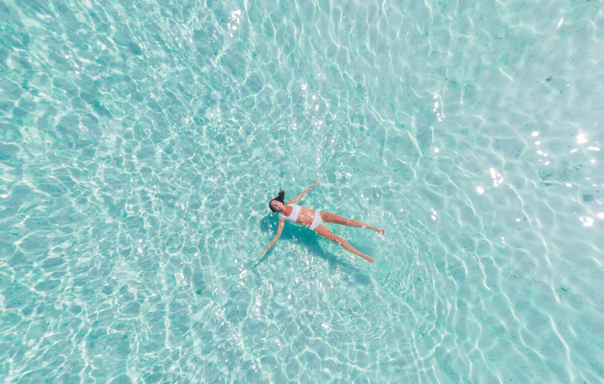 woman floating on her back in the ocean, one of many natural anxiety remedies