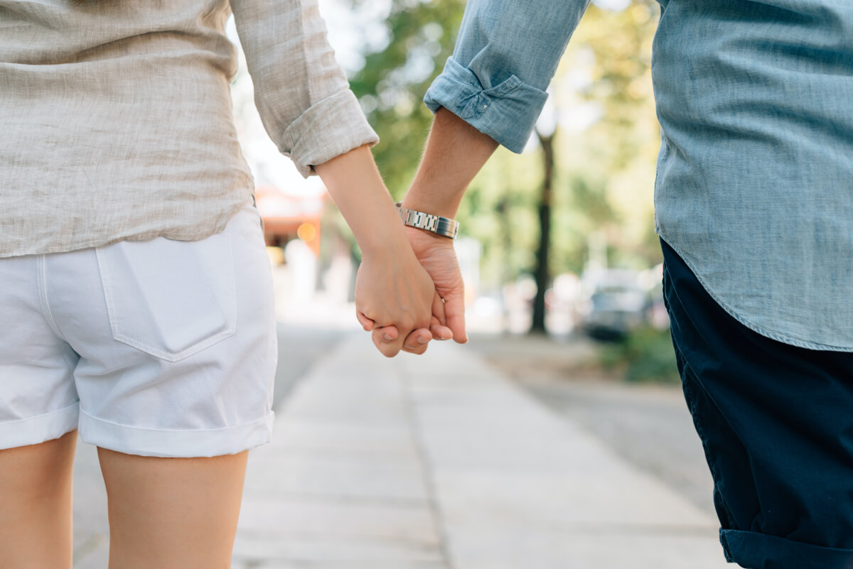 two people holding hands and walking, regina date ideas