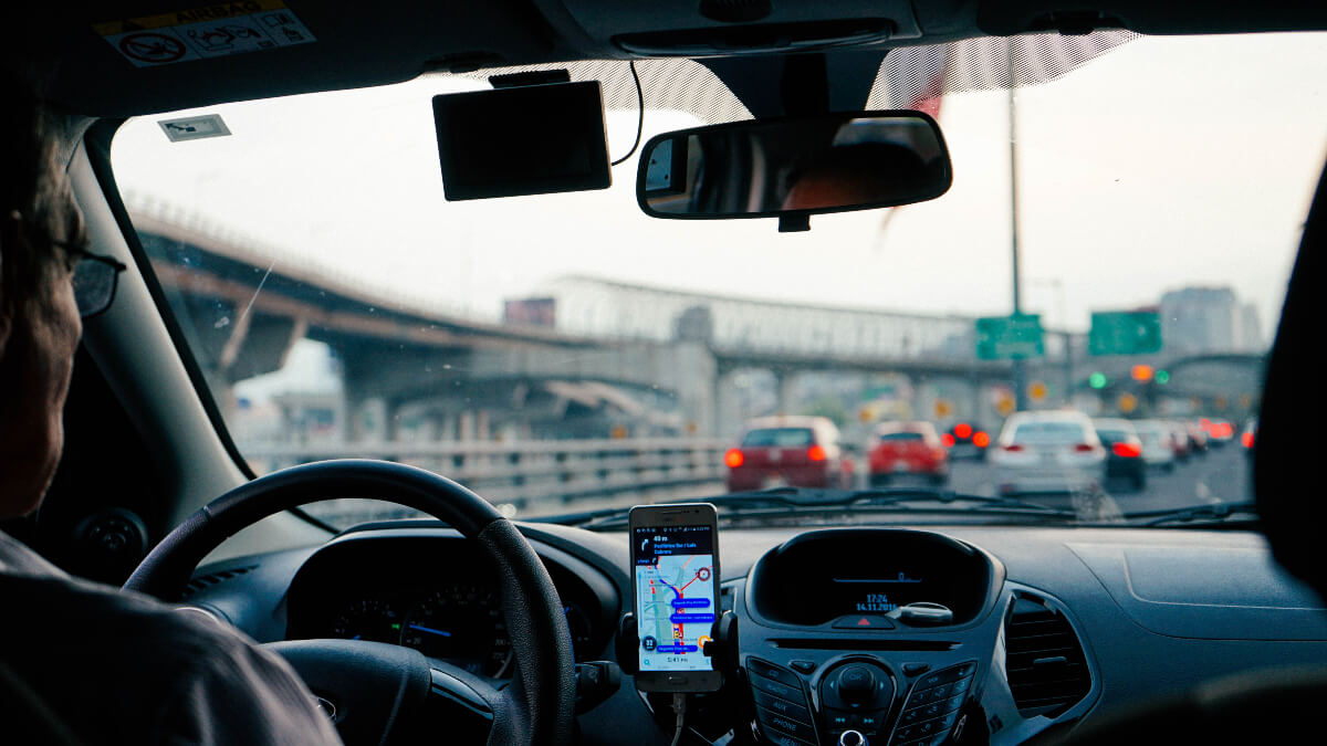 view out of windshield of a car in city traffic