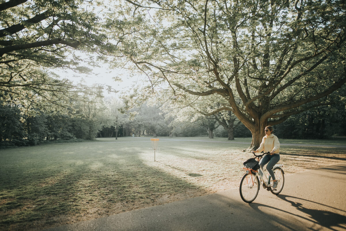 woman riding a bicycle in a park