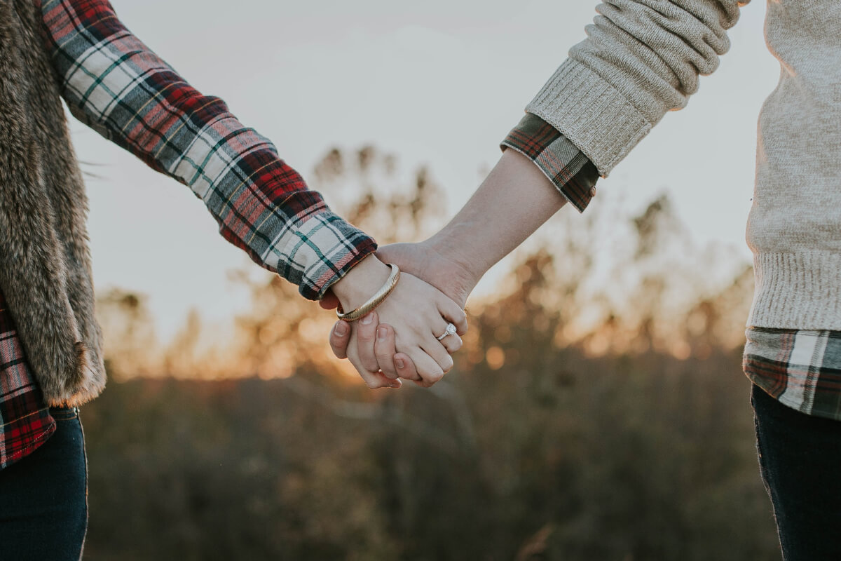 Married couple holding hands 